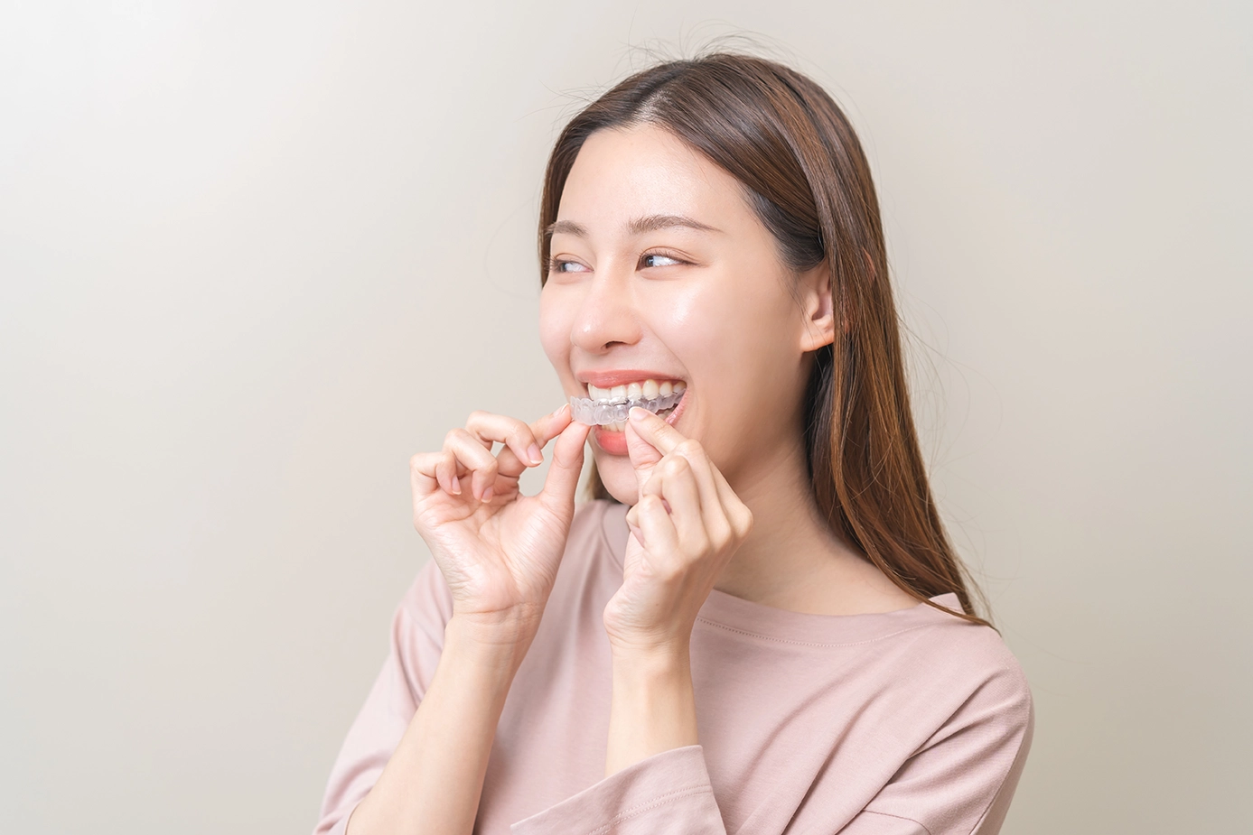 A woman trying out her new Invisalign braces